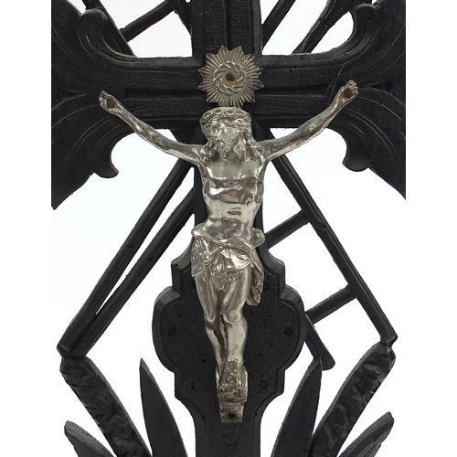 1059 - Two religious interest altar crucifixes including a ebonised carved wood example, the largest 54cm h... 