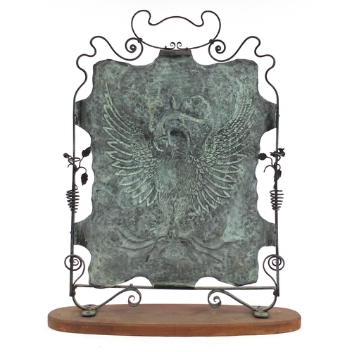 461 - Arts & Crafts copper and wrought iron fire screen embossed with a phoenix, mounted on a later staine... 