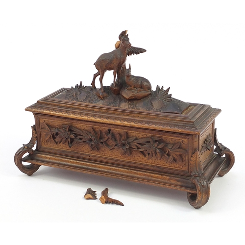 48 - Black Forest table casket with silk button back interior carved with two deer and foliage, 29.5cm H ... 