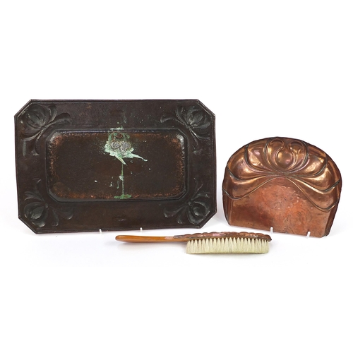 1230 - Arts & Crafts copper tray embossed with stylised flowers and a crumb tray with brush, the largest 39... 