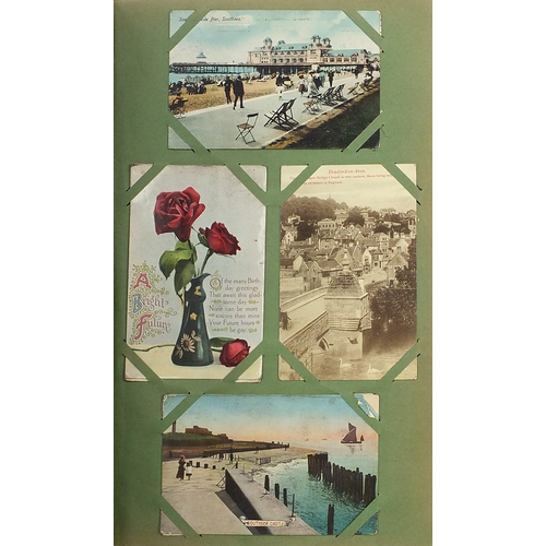 1510 - Topographical greetings and comical postcards arranged in an album including Donald McGill, street s... 