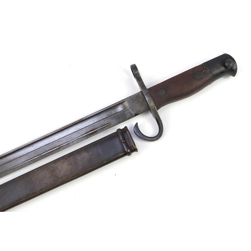 2363 - Military interest bayonet with scabbard, impressed mark to the steel blade, 52.5cm in length