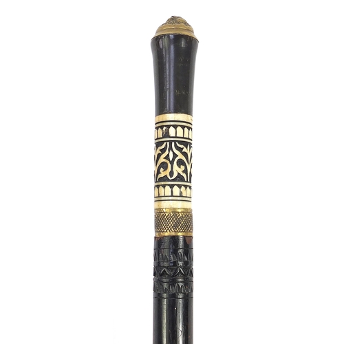 515 - Indian ebonised swordstick with horn handle, carved bone mount and steel blade, 94cm in length