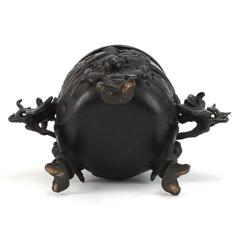 488 - Japanese patinated bronze tripod incense burner with dragon handles and pierced lid, 21.5cm high