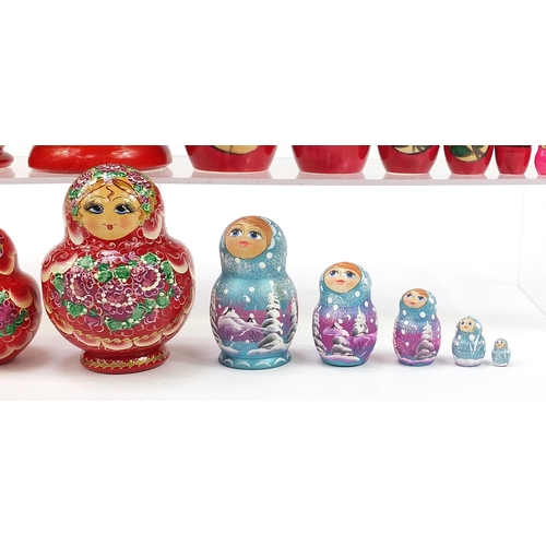 670 - Four Russian Matryoshka hand painted stacking dolls, the largest 21cm high