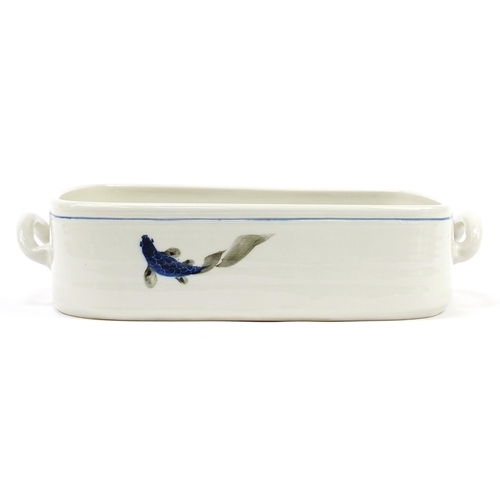 1176 - Large Johnathan Chiswell Jones twin handled casserole dish hand painted with fish, 39cm wide