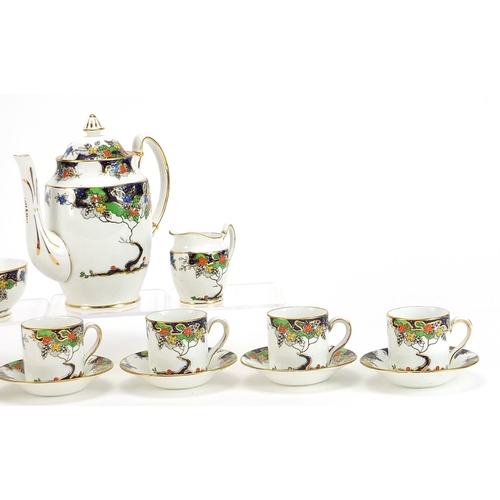 1203 - Standard China six place coffee service decorated with stylised trees and flowers, the coffee pot 17... 