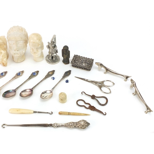 656 - Objects including antique carved stone heads, Dachshund design silver plated knife rests, silver han... 