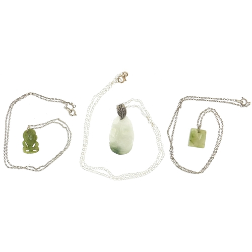 1129 - Three carved hardstone panels and white metal necklaces including New Zealand green jade example and... 