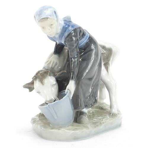 563 - Royal Copenhagen, Danish porcelain figure of a maid with a calf, 15cm high