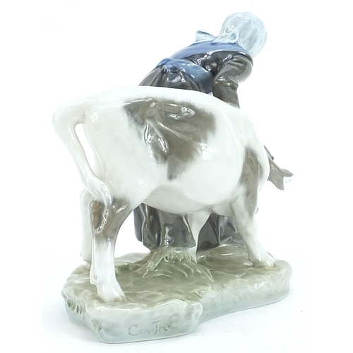 563 - Royal Copenhagen, Danish porcelain figure of a maid with a calf, 15cm high