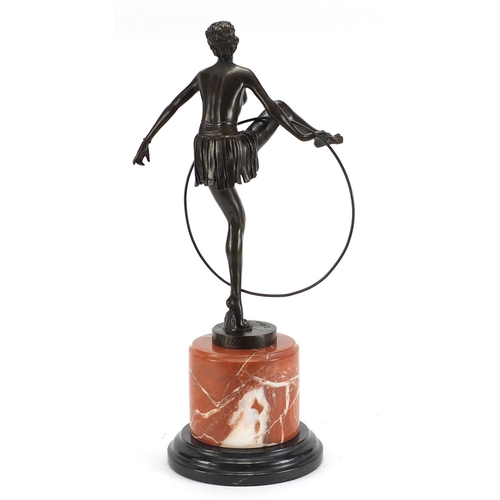 1231 - Patinated bronze study of an Art Deco hula hoop girl raised on a circular marble base, 47cm high