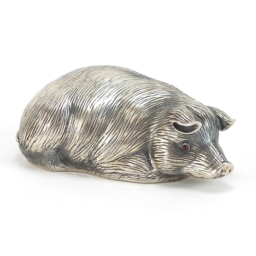 2250 - Silver model of a recumbent pig with ruby eyes, impressed Russian marks, 6cm in length, 30.8g