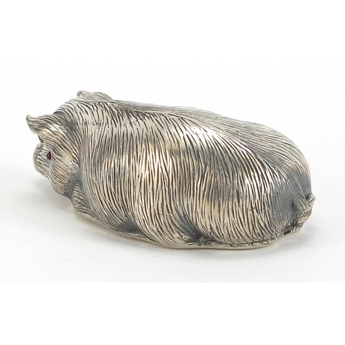 2250 - Silver model of a recumbent pig with ruby eyes, impressed Russian marks, 6cm in length, 30.8g