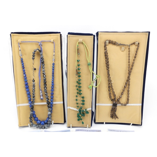 2173 - Four semi precious stone necklaces with silver clasps and certificates comprising smoky quartz, Mada... 