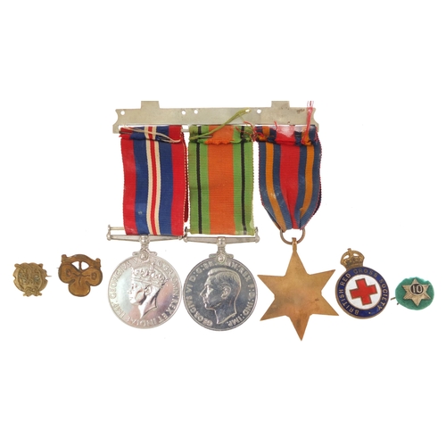 2297 - British military World War II three medal group and four badges including British Red Cross Society