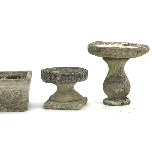 888 - Pair of garden stoneware planters and two birdbaths, the largest 35cm high