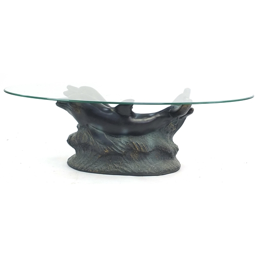 833 - Contemporary dolphin coffee table with oval glass top, 38cm H x 122cm W x 61cm D