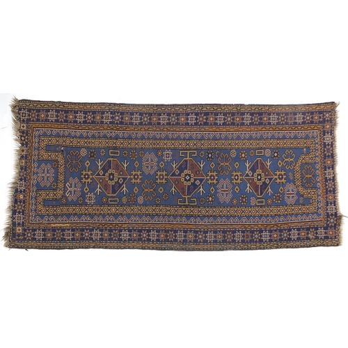 825 - Rectangular blue ground rug having an all over geometric design, 192cm x 100cm