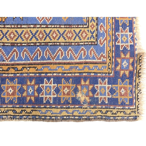 825 - Rectangular blue ground rug having an all over geometric design, 192cm x 100cm