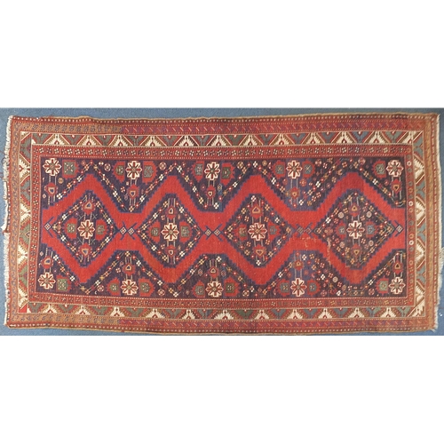 792 - Rectangular red and blue ground rug having an all over geometric design, 320cm x 178cm