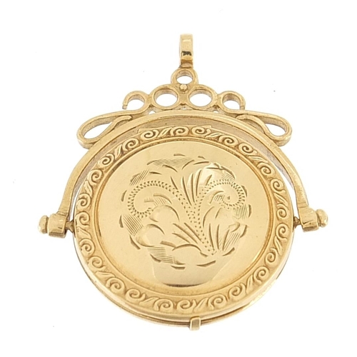 1655 - Unmarked gold spinner locket with engraved decoration, (tests as 9ct gold) 3.8cm high, 5.4g