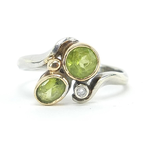 1977 - 9ct white gold peridot and diamond crossover ring, size N, 3.6g