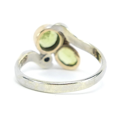 1977 - 9ct white gold peridot and diamond crossover ring, size N, 3.6g