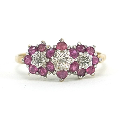 1673 - 9ct gold ruby and diamond flower head ring, size R, 2.6g