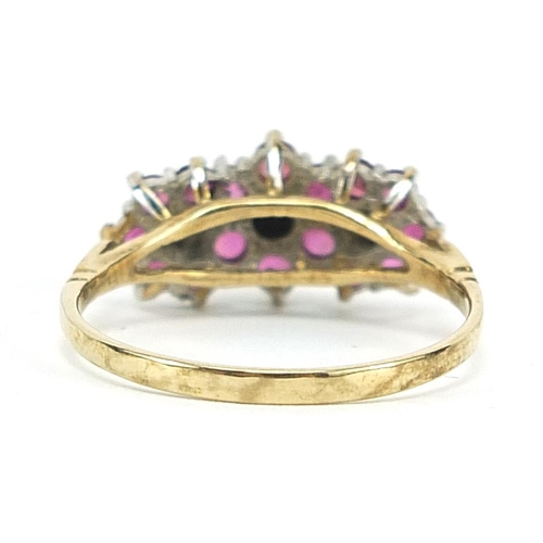 1673 - 9ct gold ruby and diamond flower head ring, size R, 2.6g