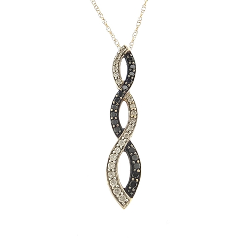 1811 - 9ct gold diamond and black diamond crossover pendant on a 9ct gold necklace, 3.3cm high and 47cm in ... 