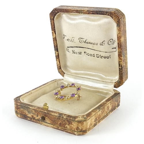 1961 - 9ct gold seed pearl and amethyst wreath brooch housed in an F B Thomas & Co box, 2.2cm in diameter, ... 