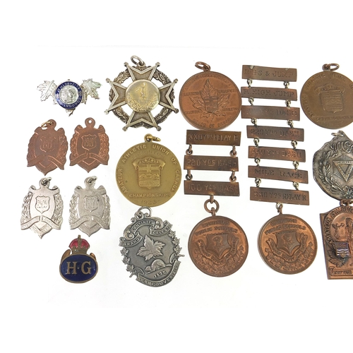 1485 - Predominantly athletic jewels and medallions, some silver including standing high jump awarded to R ... 