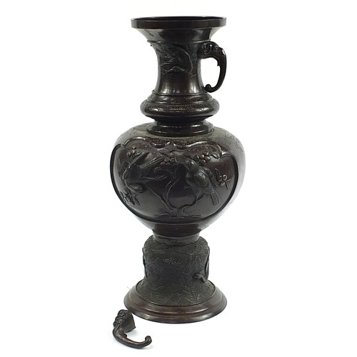 345 - Large Japanese floor standing patinated bronze vase with twin handles decorated in relief with birds... 