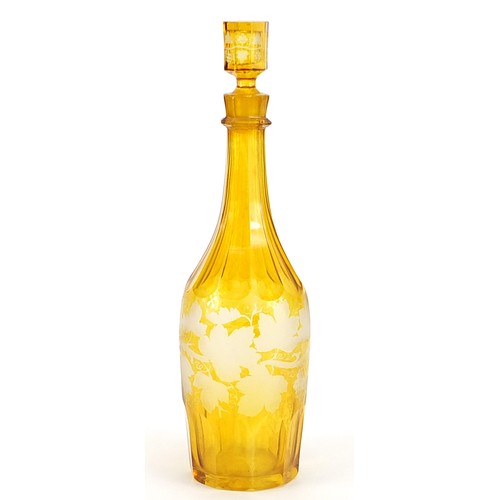 270 - Bohemian amber flashed cut glass decanter etched with leaves, 32cm high