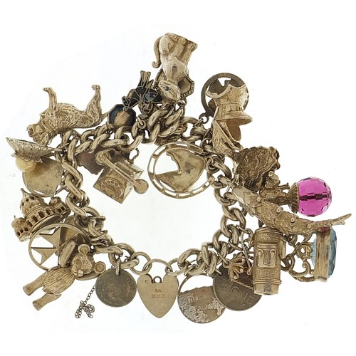 1752 - Heavy silver charm bracelet with a selection of mostly silver charms including articulated teddy bea... 