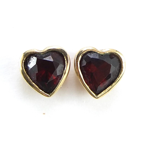 2014 - Pair of unmarked gold garnet love heart stud earrings, (tests as 9ct gold) 6mm high, 1.2g