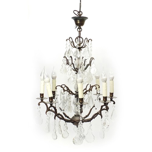 854 - Bronzed eight branch three tier chandelier with cut glass drops, 73cm high excluding the fitting