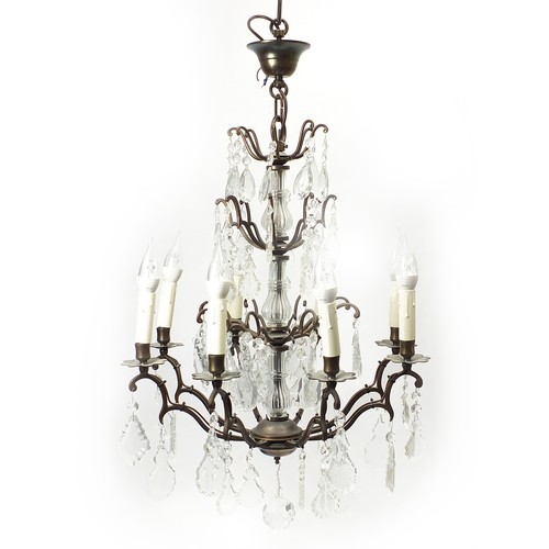 854 - Bronzed eight branch three tier chandelier with cut glass drops, 73cm high excluding the fitting