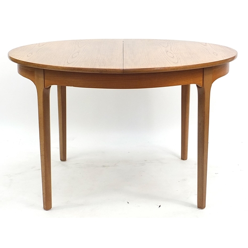 813 - McIntosh & Co, mid century Scottish teak extending dining table with four chairs, the table 75.5cm H... 