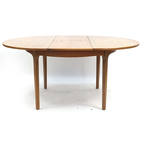 813 - McIntosh & Co, mid century Scottish teak extending dining table with four chairs, the table 75.5cm H... 