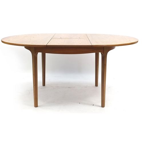 813 - McIntosh & Co, mid century Scottish teak extending dining table with four chairs, the table 75.5cm H... 