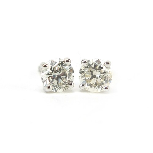 1672 - Pair of 18ct white gold diamond solitaire stud earrings, total diamond weight approximately 1.04 car... 