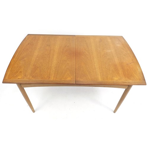 798 - G Plan E-Gomme, mid century teak extending dining table with four chairs, the table 73.5cm H x 147cm... 