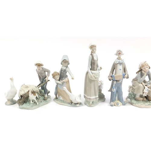 561 - Eight Lladro and other Spanish porcelain figures and animals and a Lladro the Art of Porcelain hardb... 