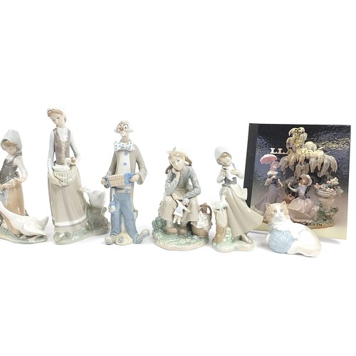 561 - Eight Lladro and other Spanish porcelain figures and animals and a Lladro the Art of Porcelain hardb... 