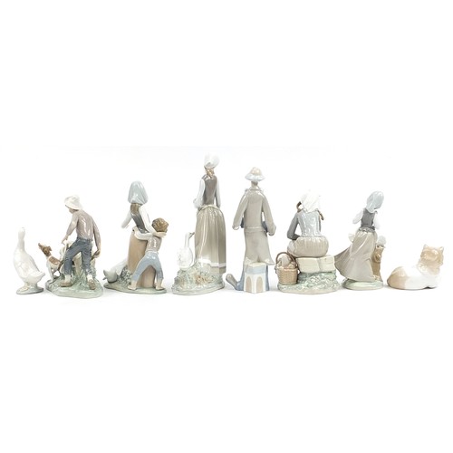 561 - Eight Lladro and other Spanish porcelain figures and animals and a Lladro the Art of Porcelain hardb... 