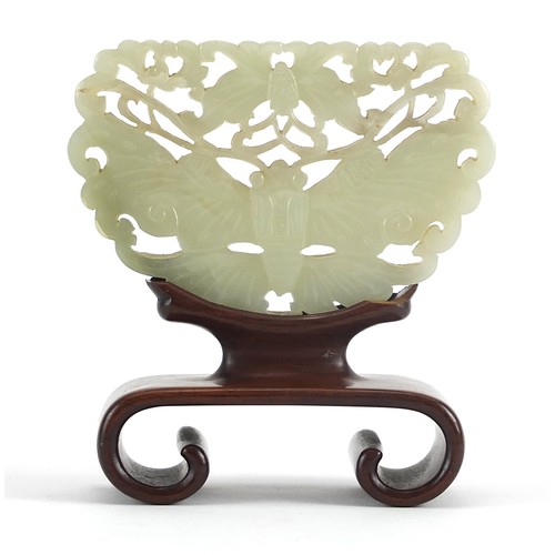 13 - Chinese celadon and russet jade panel carved with two butterflies raised on carved hardwood stand, t... 