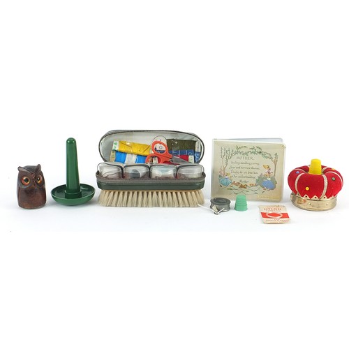 1008 - Sewing objects including carved treen owl tape measure holder and crown design pin cushion with tape... 