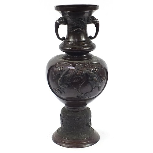 345 - Large Japanese floor standing patinated bronze vase with twin handles decorated in relief with birds... 